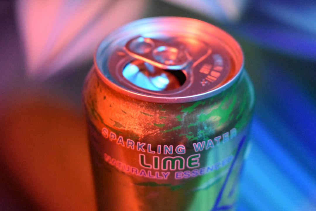 Sparkling water in an aluminum can with fresh lime