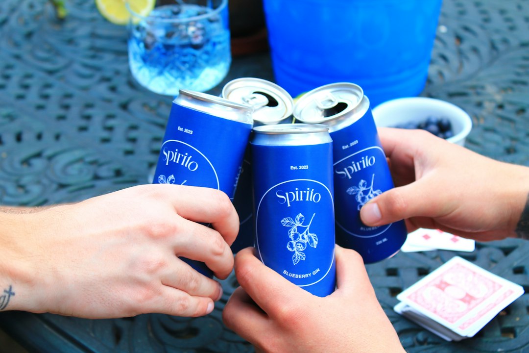 Friends sharing canned drinks outdoors